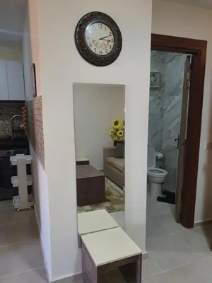 a clock on the wall of a living room at Tiba golden resort in Hurghada
