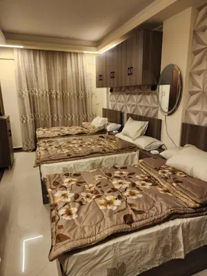 a group of four beds in a room at Cecilia Village in Hurghada