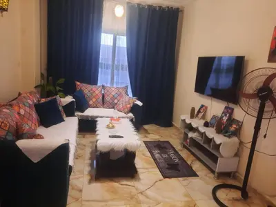 a living room with a couch and a flat screen tv at Sea view holidays in Hurghada