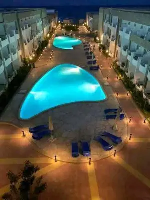 a large swimming pool in the middle of a building at Cecilia Village in Hurghada