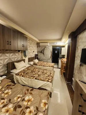 a hotel room with two beds with flowers on them at Cecilia Village in Hurghada