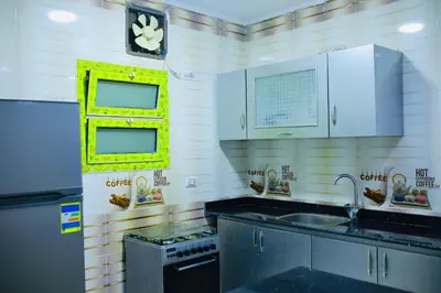 a kitchen with a sink and a stove and a window at رويال بالاس in Hurghada