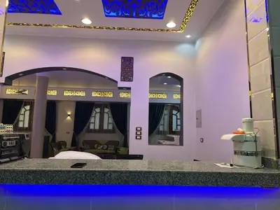 a room with purple walls and a counter with mirrors at Family House in Luxor