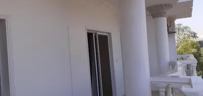 a white building with a door and a window at منزل عبد الرحيم العمدة in Luxor