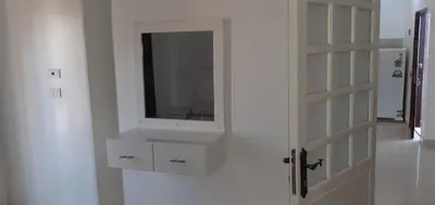 a white bathroom with a sink and a mirror at منزل عبد الرحيم العمدة in Luxor