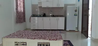 a kitchen with a refrigerator and a table in it at منزل عبد الرحيم العمدة in Luxor
