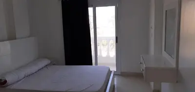 a white room with a bed and a window at منزل عبد الرحيم العمدة in Luxor