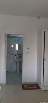 a white bathroom with a sink and a mirror at منزل عبد الرحيم العمدة in Luxor