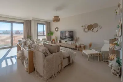 a living room with a bed and a living room with a couch at Stylish 3 BR Retreat at Ancient Hills El Gouna in El Gouna