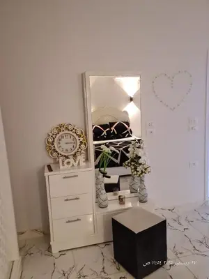 a dresser with a mirror and a dresser with a clock at White Rose House in Luxor