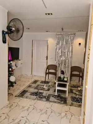 a living room with two chairs and a table at White Rose House in Luxor