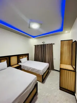 a bedroom with two beds and a blue ceiling at Royal palace in Hurghada