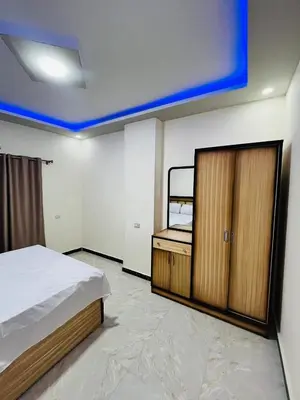 a bedroom with a bed and a wooden cabinet at Royal palace in Hurghada