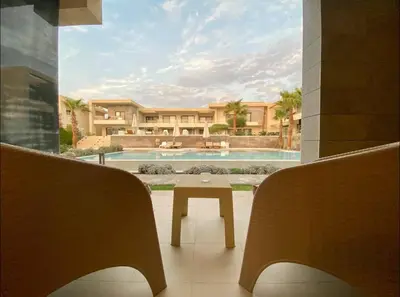 a view of a house with a pool and a table at G Cribs Pool Front Studio in Hurghada
