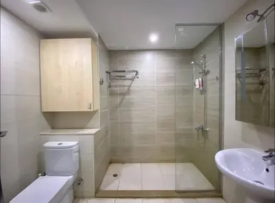 a bathroom with a shower and a toilet and a sink at G Cribs Pool Front Studio in Hurghada