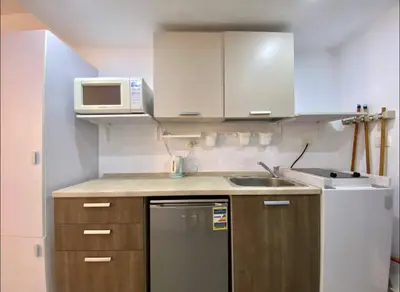 a small kitchen with a sink and a microwave at G Cribs Pool Front Studio in Hurghada