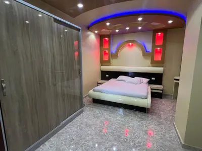 a bedroom with a bed and a shower at Apartment with sea view in Hurghada
