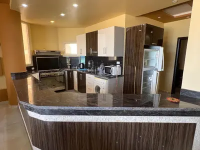 a kitchen with a large counter top with appliances at Apartment with sea view in Hurghada