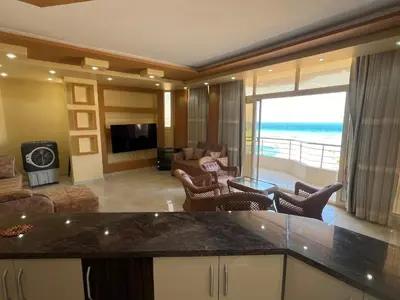 a kitchen and living room with a view of the ocean at Apartment with sea view in Hurghada
