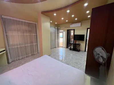 a bedroom with a bed and a fan in a room at Apartment with sea view in Hurghada