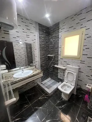 a bathroom with a sink and a toilet and a mirror at Apartment with sea view in Hurghada