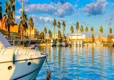 a boat is docked in a marina with palm trees at Sunset View at scandic Beach WIFI in Hurghada