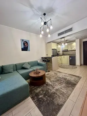 a living room with a blue couch and a kitchen at Hurghada Escape Pool and Sea View in Hurghada