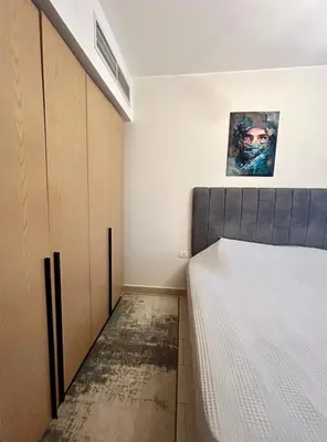 a bedroom with a bed and a painting on the wall at Hurghada Escape Pool and Sea View in Hurghada