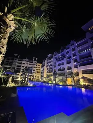 a large swimming pool in front of a building at night at Hurghada Escape Pool and Sea View in Hurghada