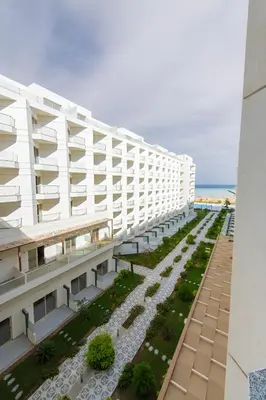 an external view of a building with a garden at Scandic Resort Hurghada in Hurghada