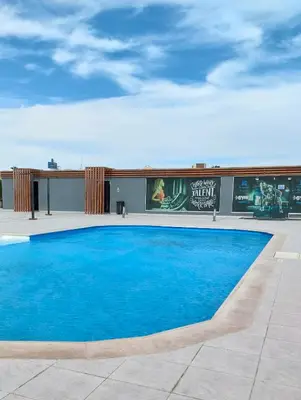 a large blue swimming pool on top of a building at Scandic Resort Hurghada in Hurghada