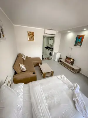 a bedroom with a bed and a living room at Scandic Resort Hurghada in Hurghada