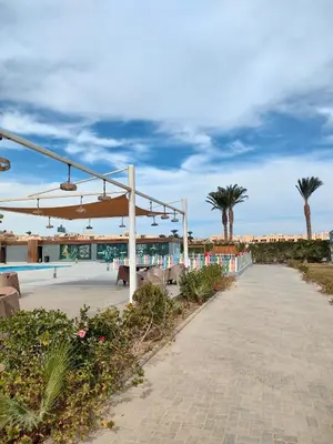 a pavilion with palm trees in the background at Scandic Resort Hurghada in Hurghada