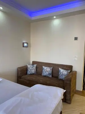 a living room with a couch and a blue ceiling at سيسليا بيتش ريزورت in Hurghada