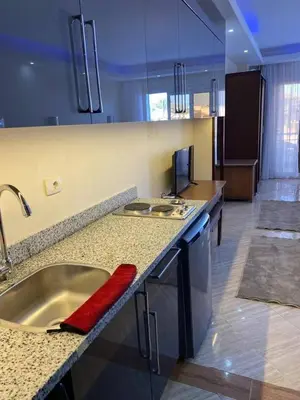 a kitchen with a sink and a counter top at سيسليا بيتش ريزورت in Hurghada