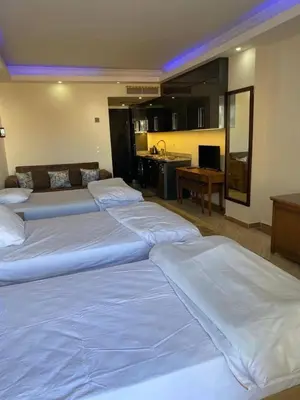 a group of three beds in a hotel room at سيسليا بيتش ريزورت in Hurghada