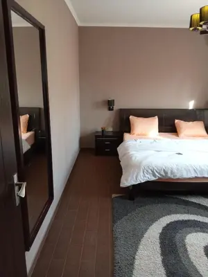 a bedroom with a bed and a mirror at , كمبواند قمريه in Hurghada
