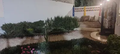 a garden with chairs and flowers in front of a building at Kemet Guest House in Aswan