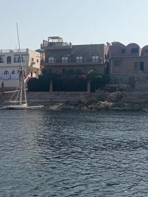 a house on the shore of a body of water at Al Agamay Nile view guest House in Jazīrat Aswān