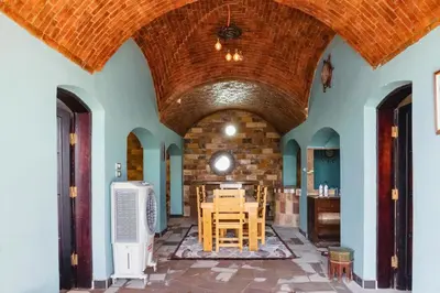 a room with a table and chairs in a building at Moon of Nuba House in Aswan
