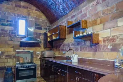 a kitchen with a sink and a stove at Moon of Nuba House in Aswan