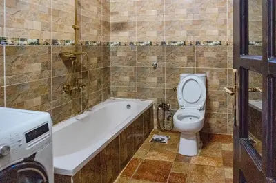 a bathroom with a toilet and a bath tub and a sink at Moon of Nuba House in Aswan