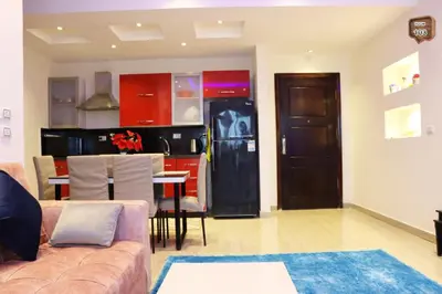 a living room with a couch and a kitchen at Relaxing apartment in Hurghada
