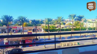 a view of a city with palm trees and buildings at Relaxing apartment in Hurghada