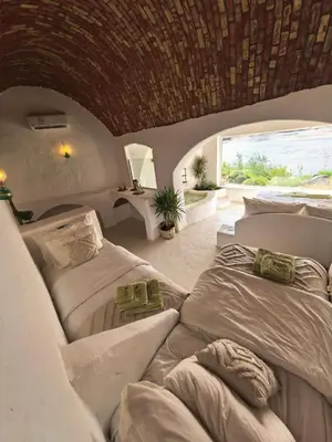 a bedroom with two beds and a window at Nala Narty Nubian House & Organic Farm in Aswan