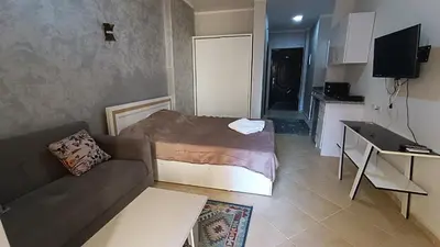 a small living room with a couch and a bed at Cozy studio Florenza Khamsin in Hurghada
