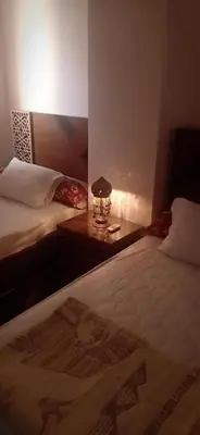 a room with two beds with a picture of jesus on the bed at Good place to enjoy vacation in Hurghada