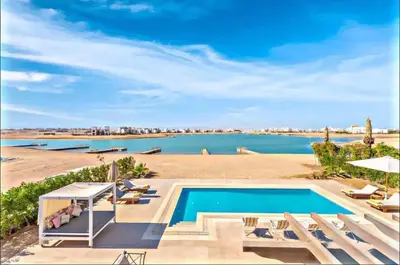 a swimming pool with a view of a body of water at Villa luxury 5bedroom in gouna in Hurghada