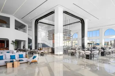 a lobby with tables and chairs in a building at Albatros Makadi Resort - 24 HRS All Inclusive in Hurghada