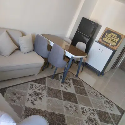 a living room with a couch and a table at Golden Tayeb Hurghada Compound in Hurghada